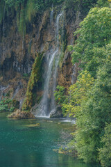 Fototapeta na wymiar Majestic view on waterfall with turquoise water in the Plitvice Lakes National Park, Croatia