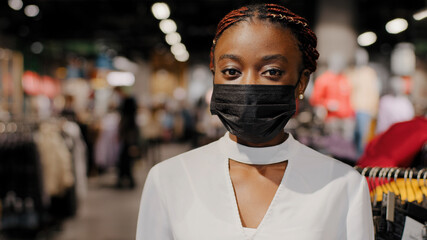 Portrait of african american girl woman shopper consumer female consultant salesperson wears black...