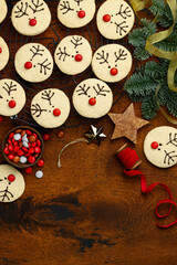 Christmas shortbread  cookies  reindeer on a wooden background. Children's festive dessert. Funny beer  biscuits. Top view, copy space. 