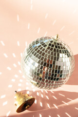 Minimal creative. Christmas decorations and mirror disco balls on sand color background.