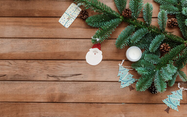 Obraz na płótnie Canvas Christmas composition. Fir tree branches on wooden background. Christmas, winter, new year concept. Flat lay, top view, copy space