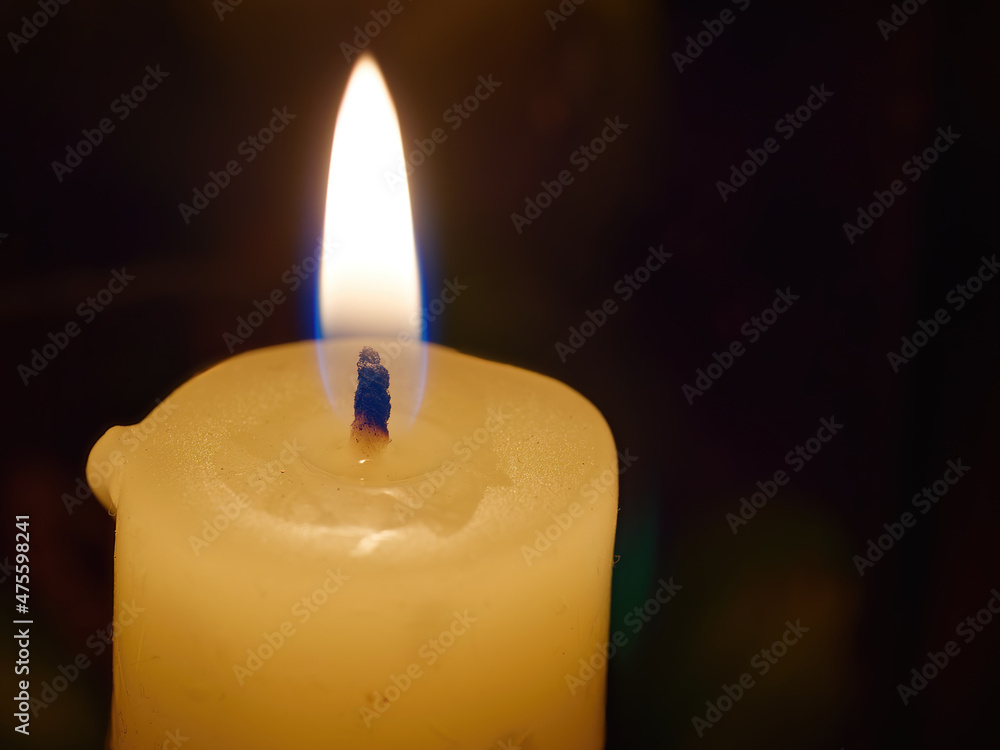 Sticker Closeup of a burning white candle