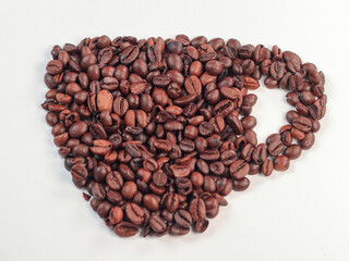 Cup shape made of coffee beans on white background