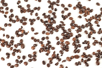 Top view of coffee beans scattered on white background.