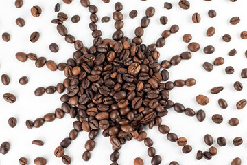 Sun symbol made from roasted coffee beans on the white background.  