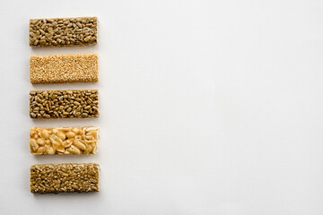 Traditional oriental sweets kozinaki on a white table, top view.