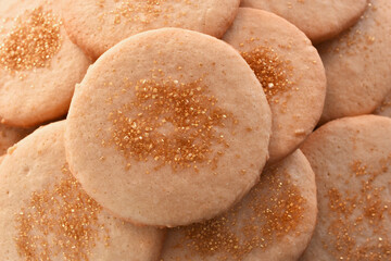 A top view image of homemade sugar cookies with gold colored sprinkles. 