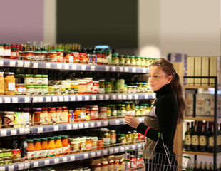 Woman choosing a dairy products at supermarket