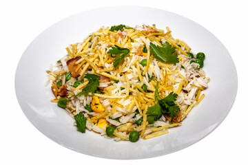 Biro-biro rice is a typical Brazilian dish to accompany or as a main course. Parsley, potato sticks, peas, egg, and bacon. Isolated on round plate