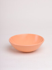 orange ceramic bowl on a light background