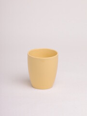 yellow ceramic coffee cup on a light background