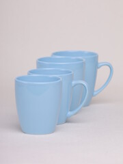 blue ceramic glasses on a light background - 475609449