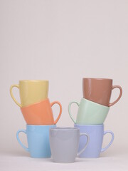 colored ceramic glasses on a light background - 475609454