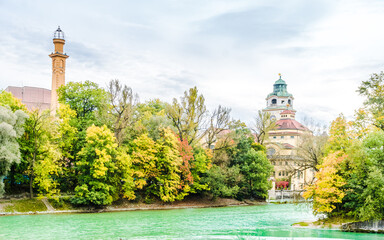 View on Colorful autumn landscape in front of Mueller Volksbad of Isar river - Munich