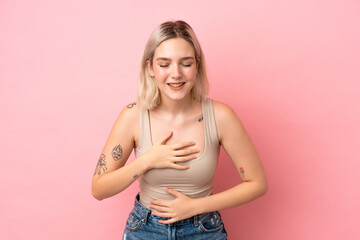 Young caucasian woman isolated on pink background smiling a lot