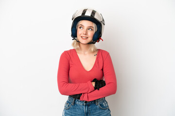 Young caucasian woman with a motorcycle helmet isolated on white background thinking an idea while looking up