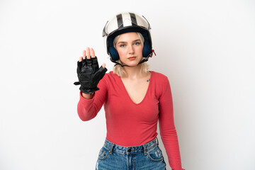 Young caucasian woman with a motorcycle helmet isolated on white background making stop gesture