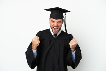 Young university Brazilian graduate isolated on white background celebrating a victory in winner...