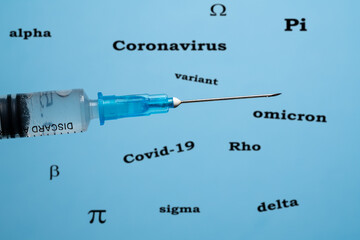 Concept of effectiveness of vaccines against covid-19 with hypodermic syringe in front of words...