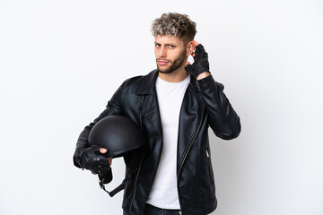 Young man with a motorcycle helmet isolated on white background having doubts