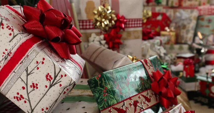 Huge pile of Christmas presents with train running in background. 4K.