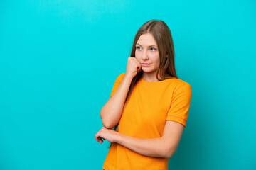 Young Russian woman isolated on blue background with tired and bored expression