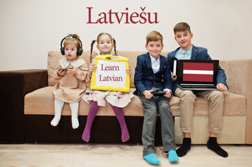 Four kids show inscription learn latvian. Foreign language learning concept. Latviesu.