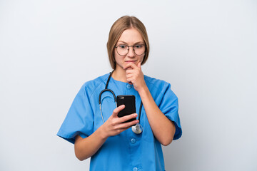 Young nurse doctor woman isolated on white background thinking and sending a message