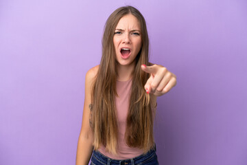 Young Lithuanian woman isolated on purple background frustrated and pointing to the front