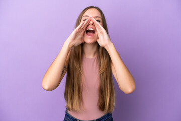 Young Lithuanian woman isolated on purple background shouting and announcing something