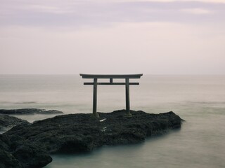 Ibaraki,Japan - December 17, 2021: A torii or a Shinto gateway shrine gate on the rock in the sea
