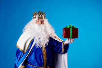 The Magician King with a present on a blue background