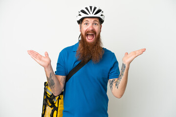 Young reddish caucasian man with thermal backpack isolate don white background with shocked facial expression