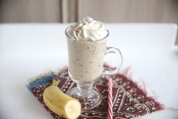 Closeup cocktail with cream and chocolate vanilla cream dessert milk beverage milkshake drink banana table towel cafe