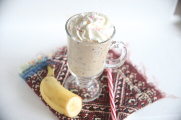 Closeup milkshake with cream and fruit sweet dessert sugar tasty drink beverage milk vanilla cream food table breakfast glass