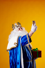 The wise men using a mobile phone on yellow background