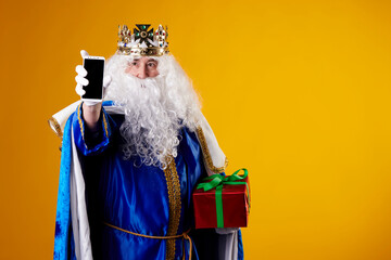 The Magician King using a mobile phone on yellow background