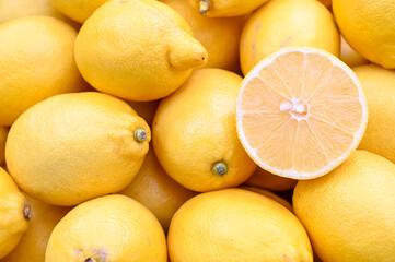 Fresh and delicious lemons for sale at vegetable market, close up. Boxes full of lemons in shop. Lemon at the greengrocer's stall. Fruit market.