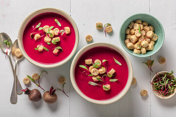 Red borsch soup with croutons and cream.