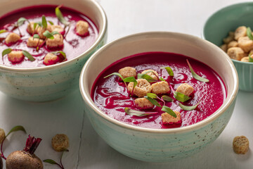 Veggie borsch soup with croutons and cream.