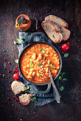 Delicious minestrone soup served with whole grain bread.