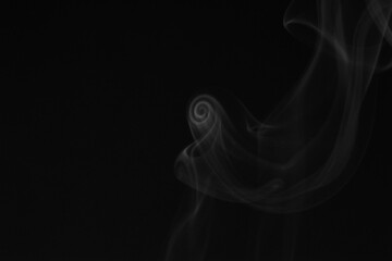 Close up of incense smoke on black background