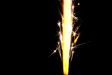 Close up of burning candle sparkler on black background