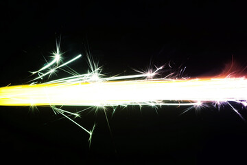 Close up of burning candle sparkler on black background