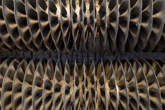 Close-up detail of metal circular heater radiator system.