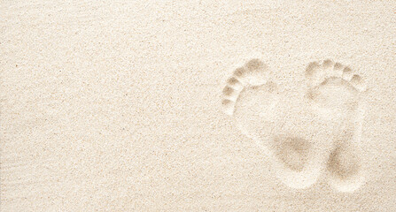 Texture background Footprints of human feet on the sand, top view with copy space