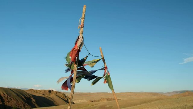 Religious tibetan buddhist prayer flags are flutter in the wind on blue sky background.