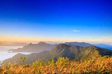 Starlight Sunrise scene with the peak of mountain called Phu Chifa at Chiangrai Thailand with Fog over the city below