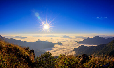 Starlight Sunrise scene with the peak of mountain called Phu Chifa at Chiangrai Thailand with Fog over the city below