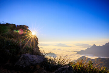 Starlight Sunrise scene with the peak of mountain called Phu Chifa at Chiangrai Thailand with Fog over the city below